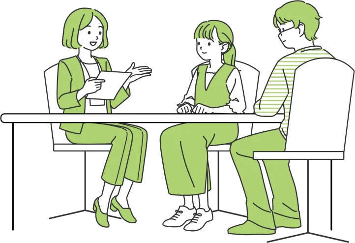 机を囲んで話し合う3人の若者のイラスト